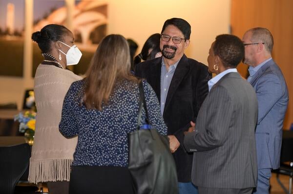 faculty standing and chatting